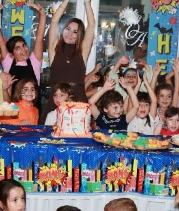 Children and staff cheering with their hands in the air
