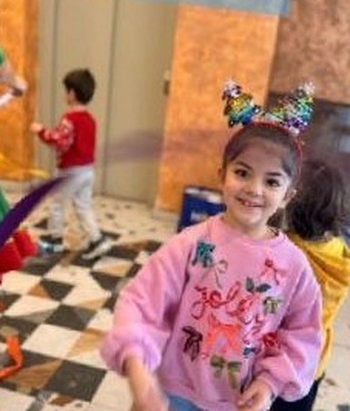 A child dancing in the big play hall