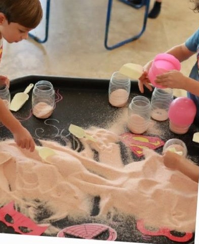 Close-up of a foamy water-play table with cups